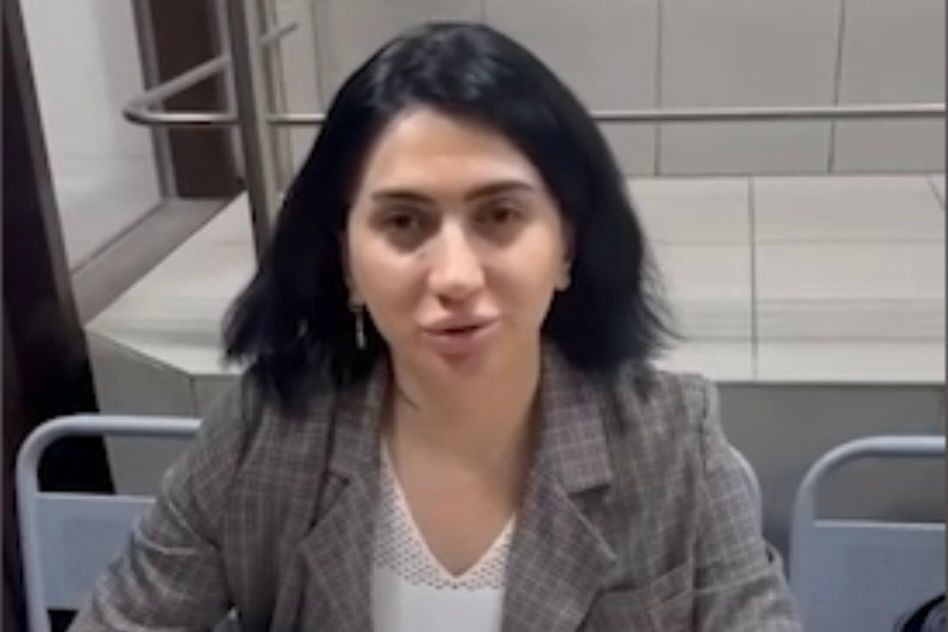 Tamar Saliya, a Georgian woman in Moscow, making a public apology at the police station. Screengrab from video.