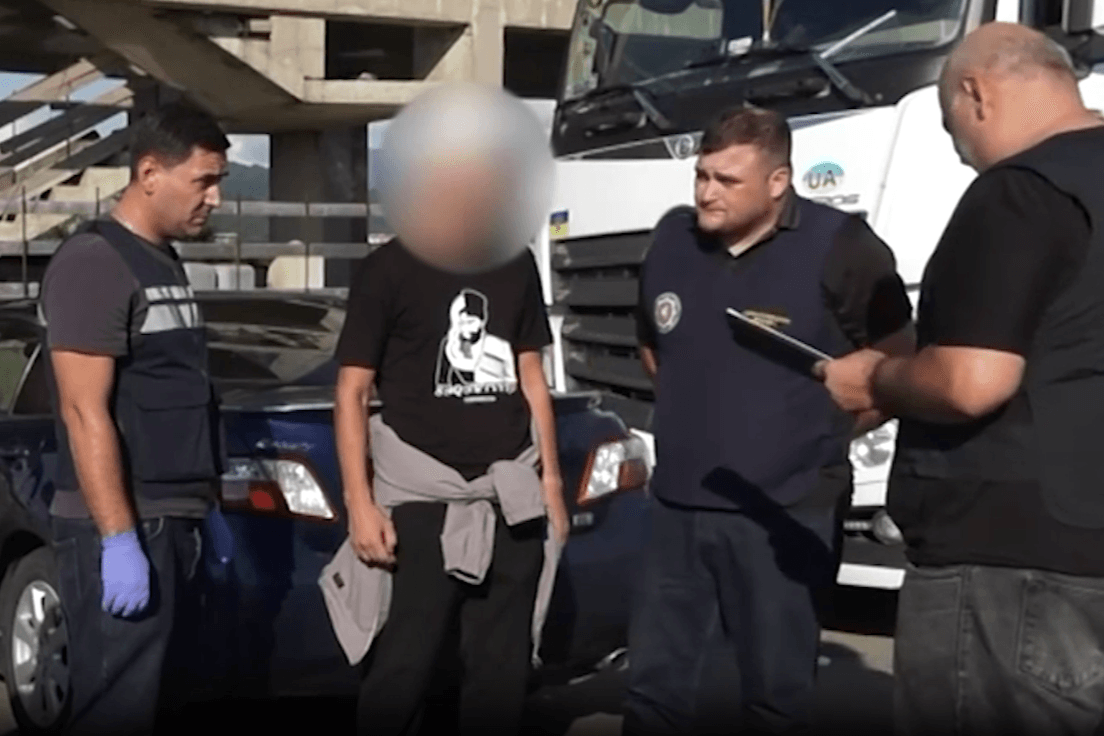 Officers from Georgia’s State Security Service (SSG) interrogate a suspect in the case. Screengrab from a video from the SSG.