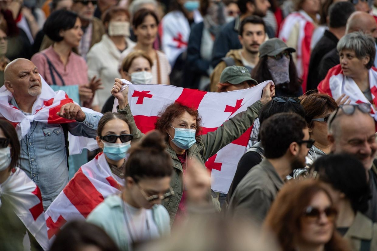 A participant of the 4 October rally waving the Georgian flag in central Tbilisi. Photo: Mariam Nikuradze/OC Media.