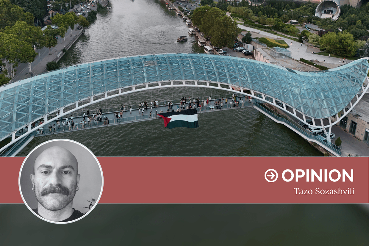 Activists unfurl a Palestinian flag from the Bridge of Peace in Tbilisi. Courtesy photo.