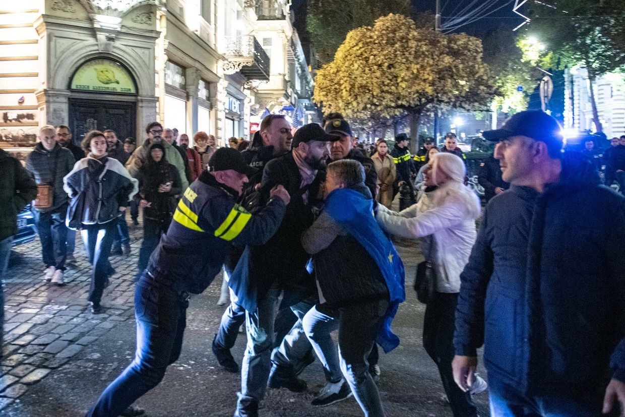 Police detain a protester as others try to protect him on the night of 21 November. Photo: Mariam Nikuradze/OC Media.