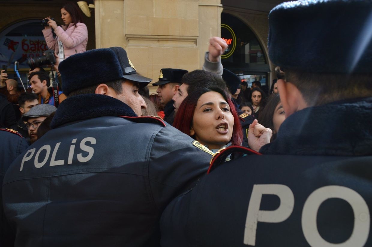 Azerbaijani activist Gulnara Mehdiyeva surrounded by police as they break up a 2020 demonstration. Photo: Vugar Mirzabey.