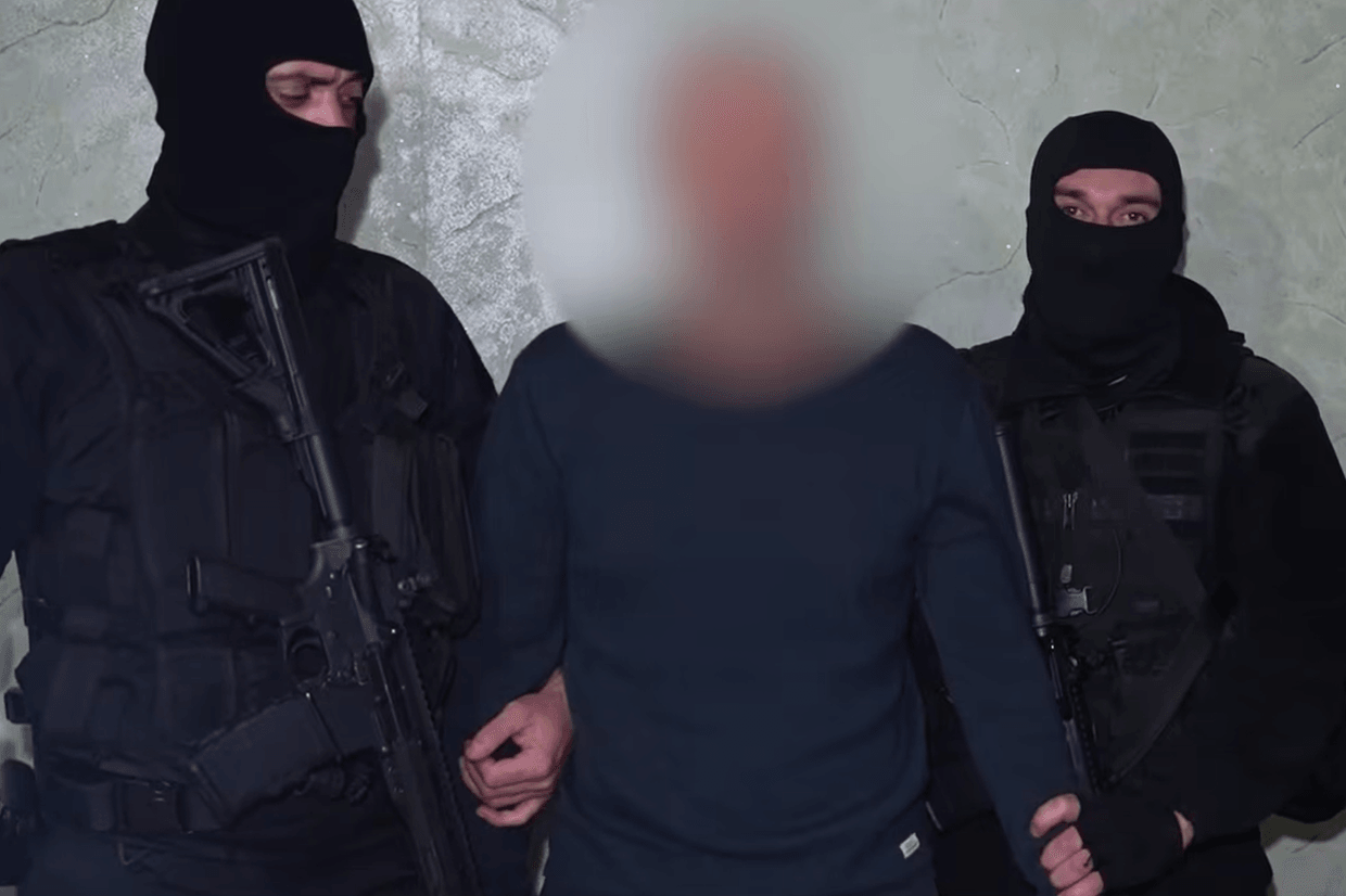 Police detain a man allegedly involved with the ‘criminal underworld’. Screengrab from video.