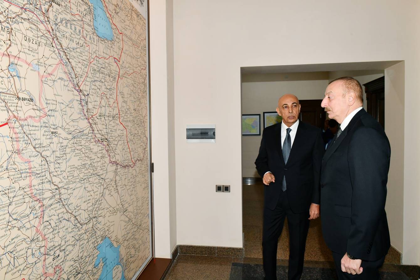 Azerbaijani President Ilham Aliyev looking at maps at the administrative building of Western Azerbaijan Community in December 2022. Official photo.