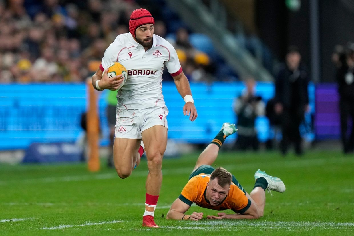 Georgia’s Aka Tabutsandze (left) runs away from Australia’s Darby Lancaster just before scoring a try against Australia during their rugby union test match in Sydney on 20 July 2024. For illustrative purposes. (AP Photo/Rick Rycroft).