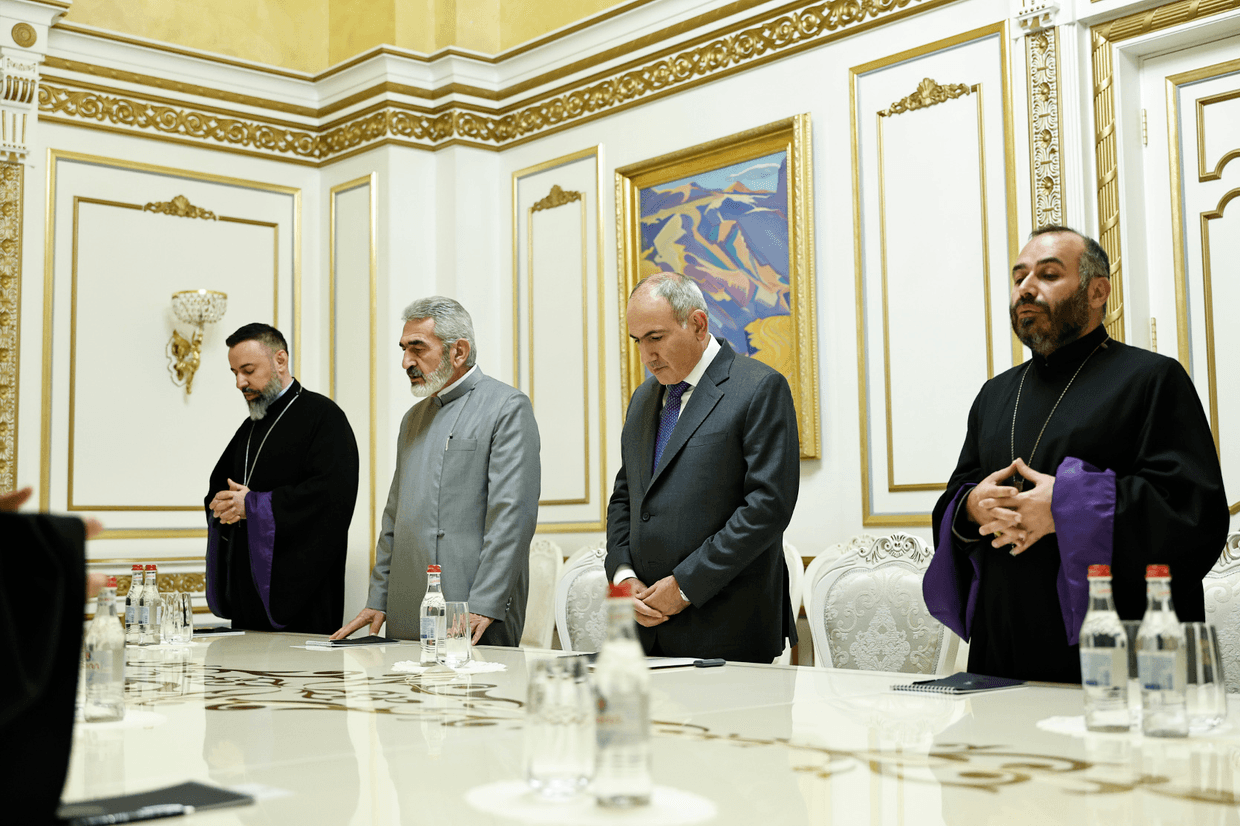 Archbishop Abraham Mkrtchyan standing to the left of Prime Minister Nikol Pashinyan during a meeting in November 2025 with a group of high-ranking clergy. Official photo.