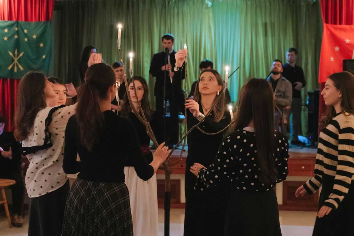 Young women light a sapling with seven branches during a celebration of New Year in 2023. Photo courtesy of Rustam Nahush.