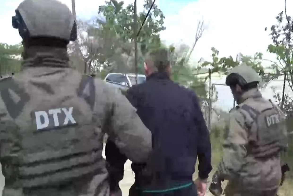 Azerbaijani security officials escorting a suspect. Screenshot from video.