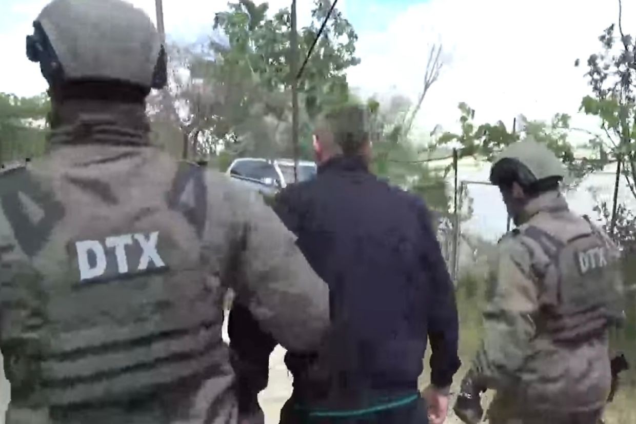 Azerbaijani security officials escorting a suspect. Screenshot from video.
