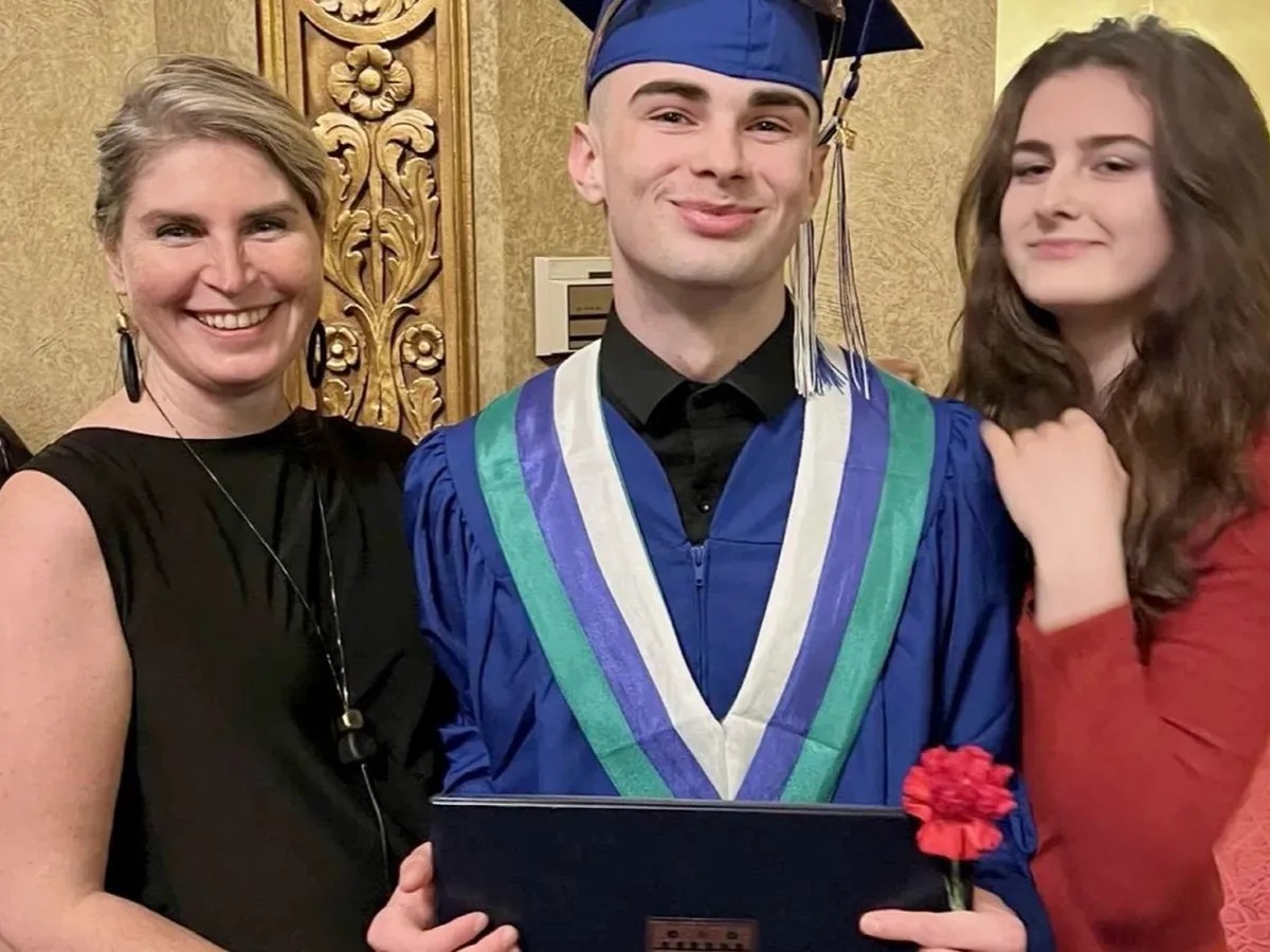 Simon Rovensky, a 22-year-old reportedly detained in Tbilisi, standing with his family members. Photo via the family archive.