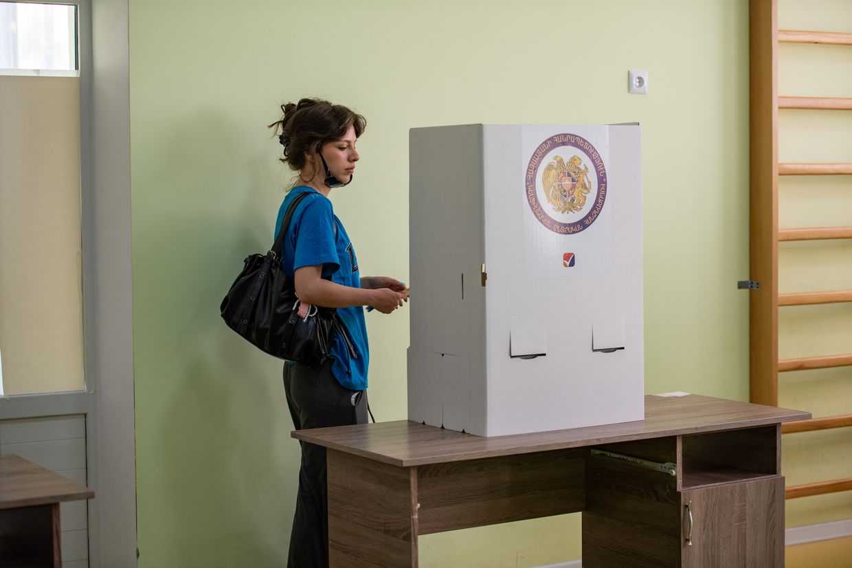 A woman casts her ballot at a polling station in Yerevan. Photo: Mariam Nikuradze/OC Media.