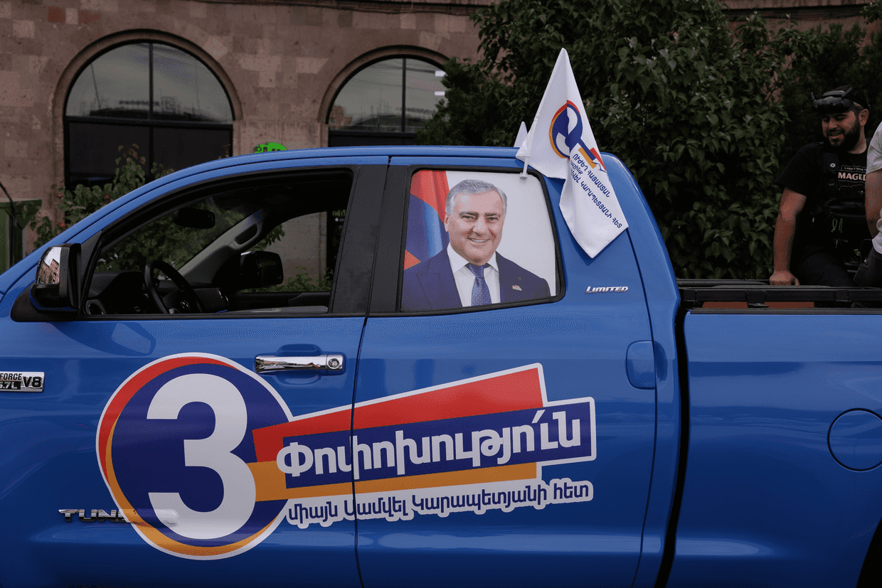 A photo of Samvel Karapetyan along with the Strong Armenia Alliance logo on a car during Armenia's pre-election campaign period. Photo: Anthony Pizzoferrato/OC Media.