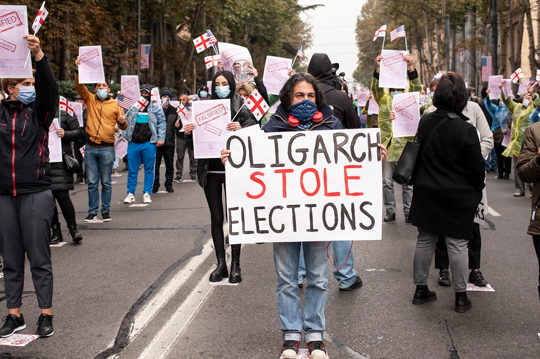 A person holds a sign criticising Bidzina Ivanishvili during a demonstration in Tbilisi. Photo: Mariam Nikuradze/OC Media.