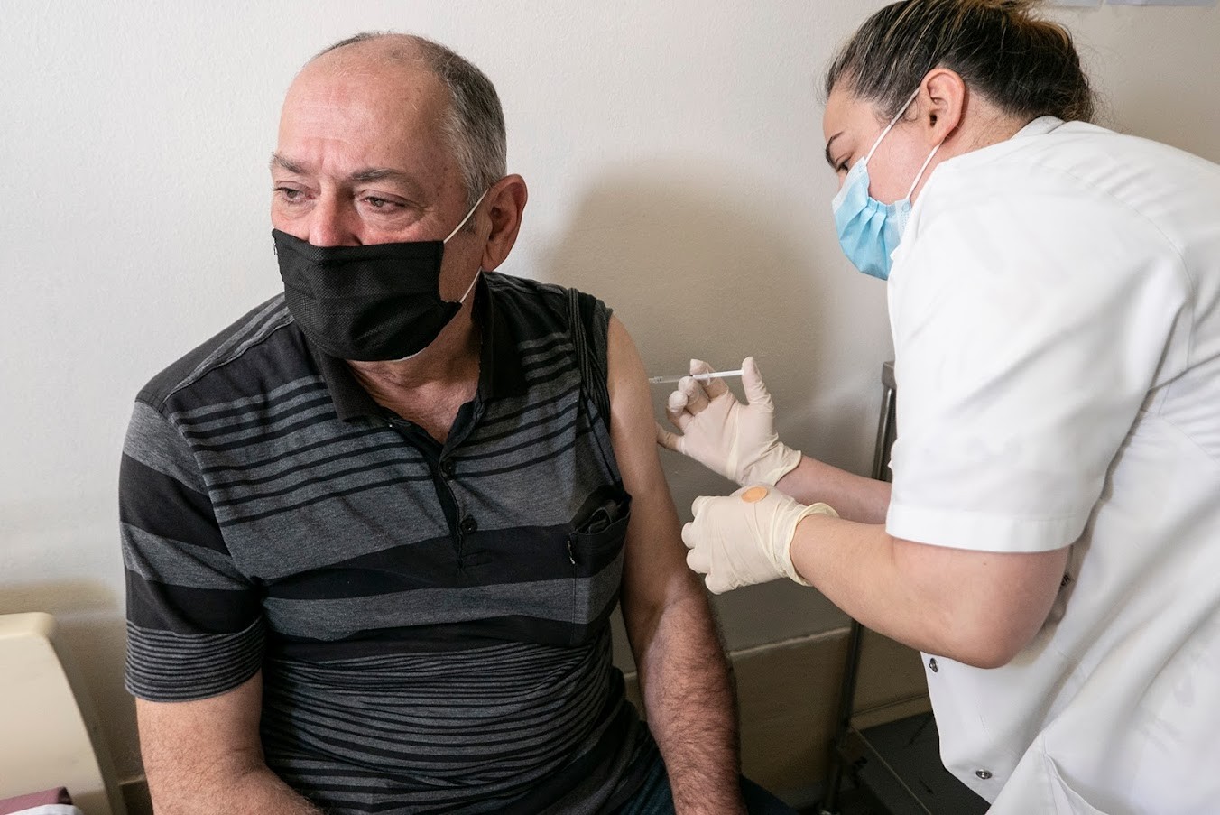A man receives a COVID-19 vaccine. Photo: Mariam Nikuradze/OC Media.