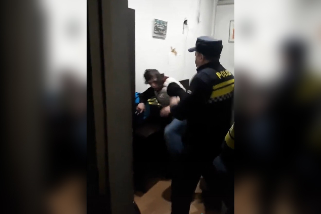 A still from the video showing a police officer beating a deaf boy in Tbilisi.