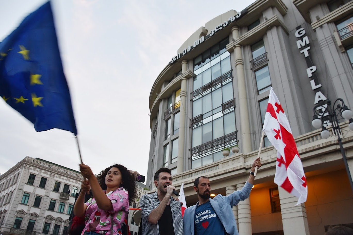 Activists wave the flags of Georgia and the EU at a demonstration in Tbilisi. Photo: OC Media.