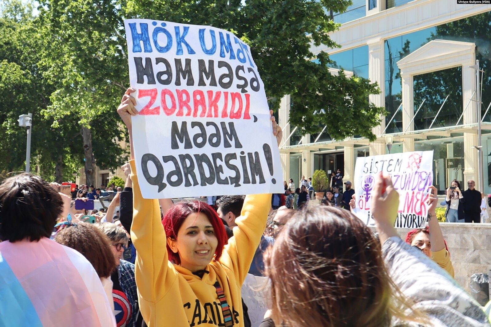 Feminist activist Gulnara Mehdiyeva holds an anti-government poster at the protest on 14 May. Photo: Ulviyya Guliyeva/VOA.