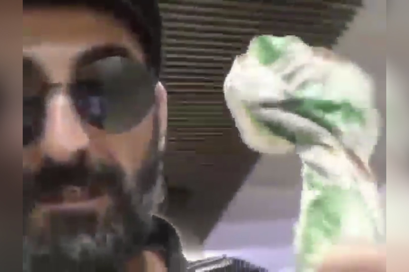 A still from the video posted by Roman Mammadov in which he brandishes what he says is an axe.