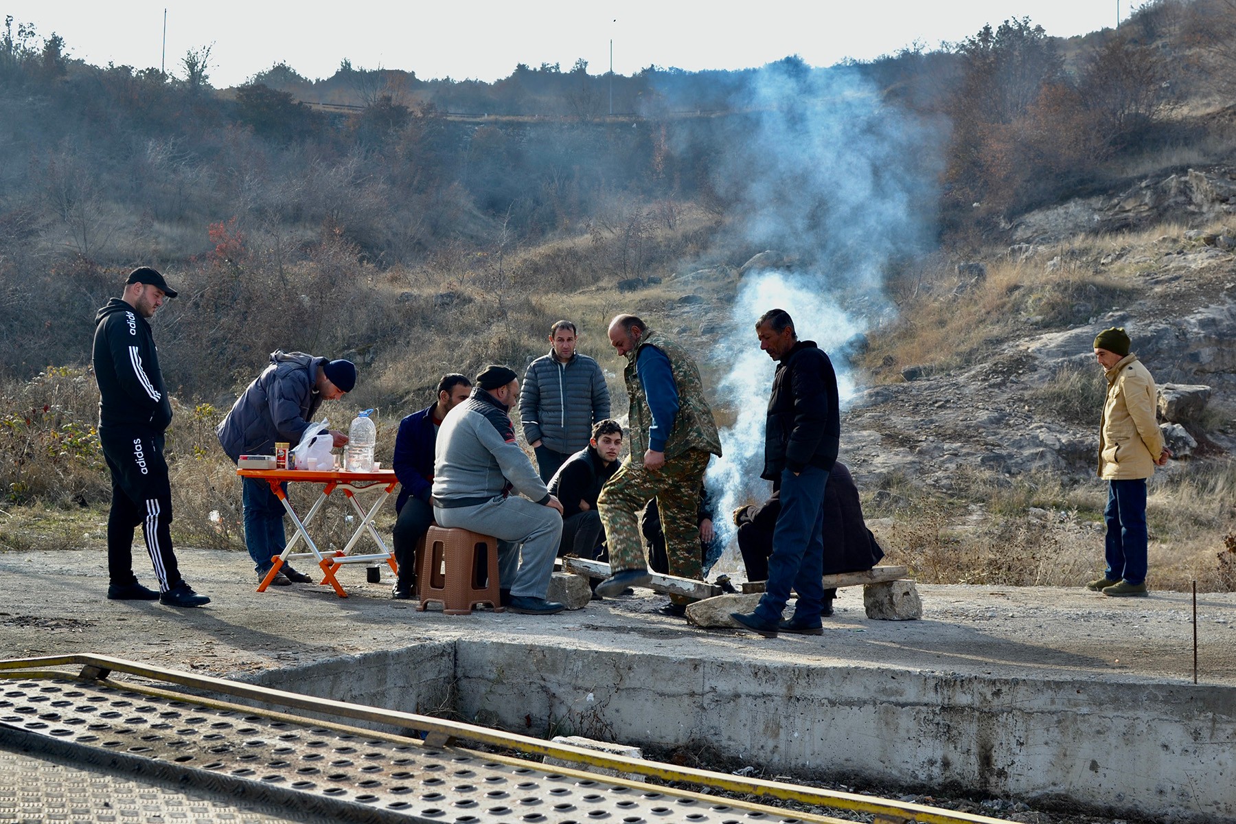 A group of men sit around a fire near the police checkpoint outside Stepanakert. Photo: Marut Vanyan/OC Media.
