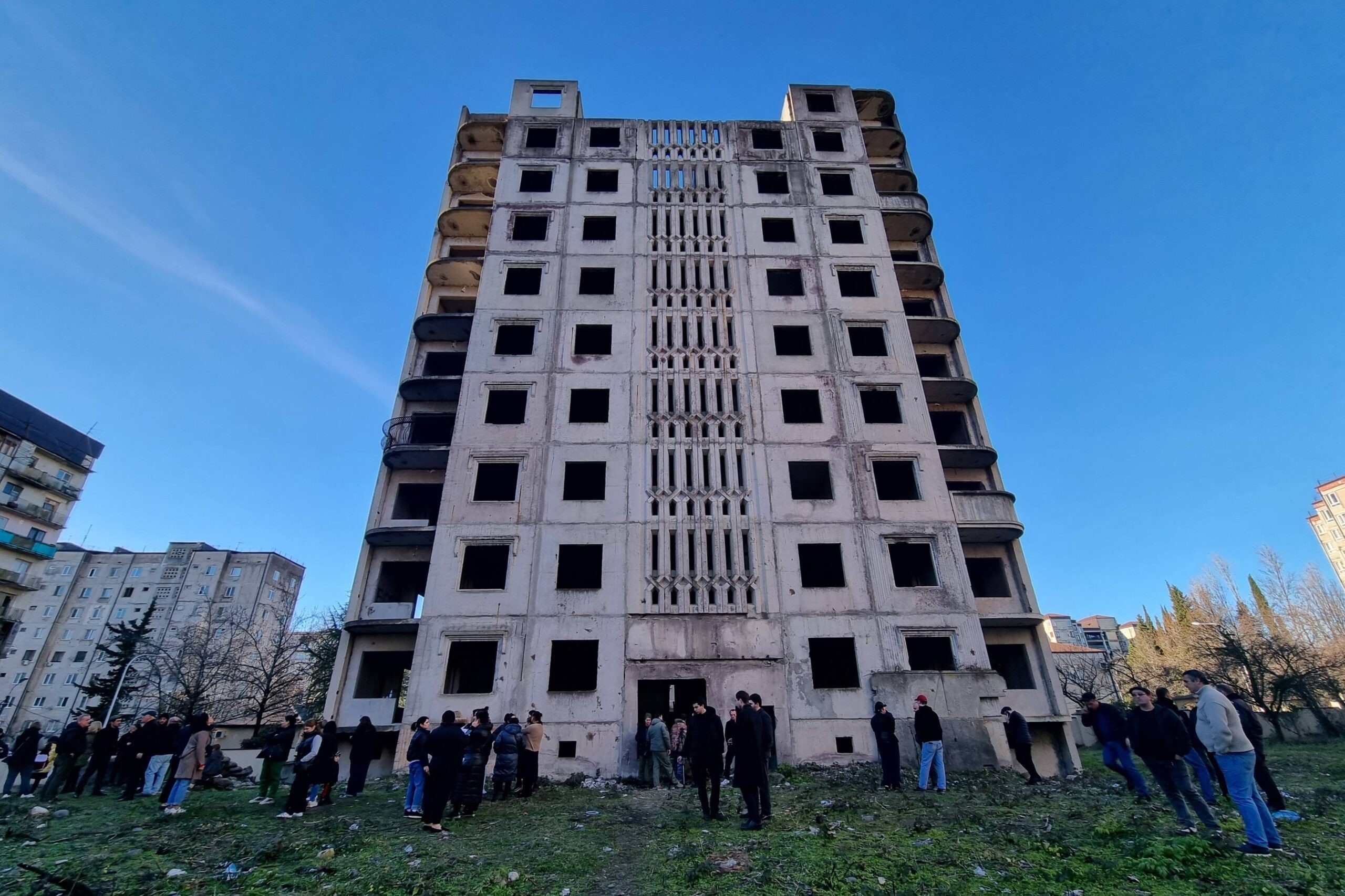 Protesters outside an abandoned high-rise building in Sukhumi's New District on 20 January. Photo: OC Media