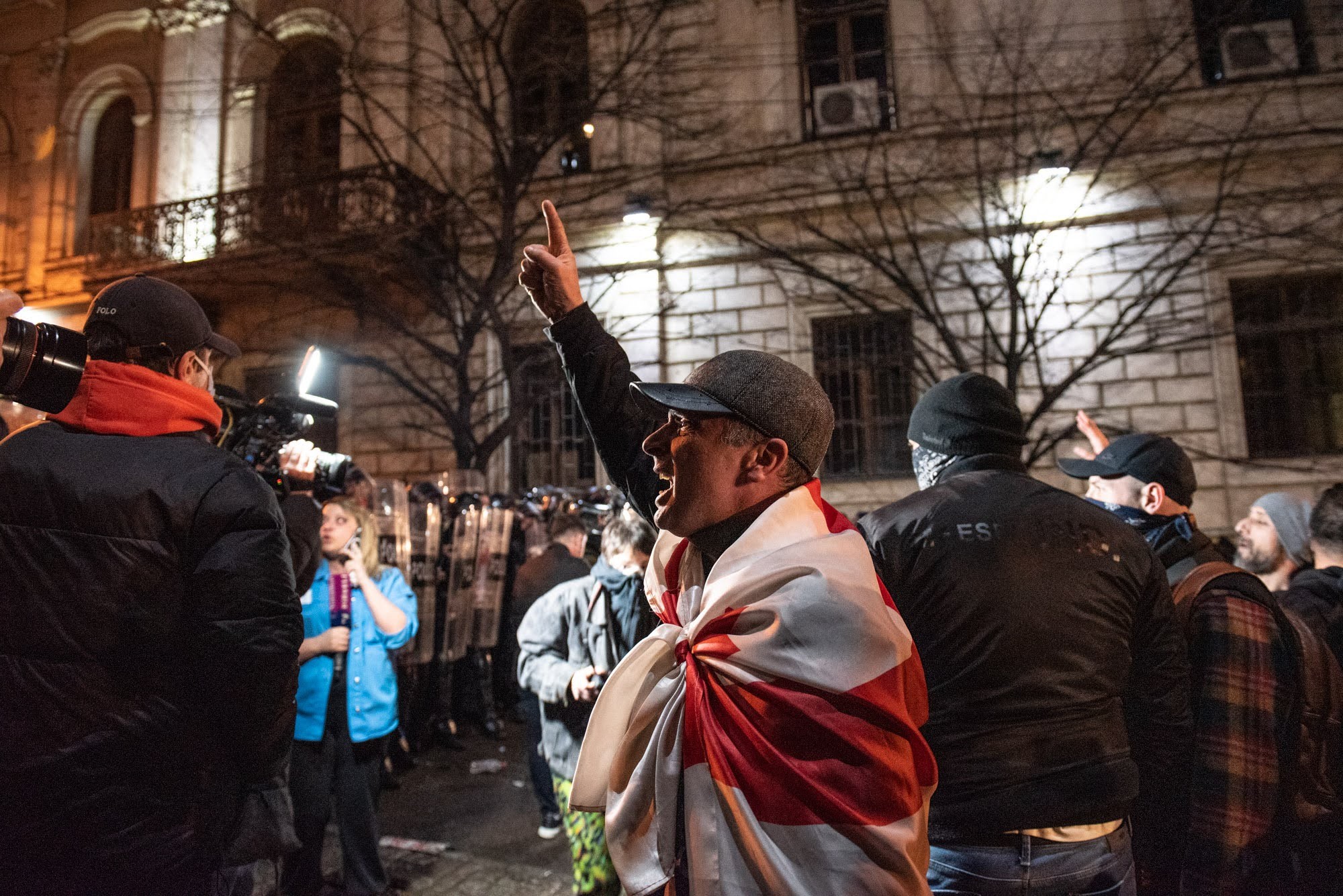 A man draped in a Georgian flag during the protests against the foreign agent law. Photo: Mariam Nikuradze/OC Media.