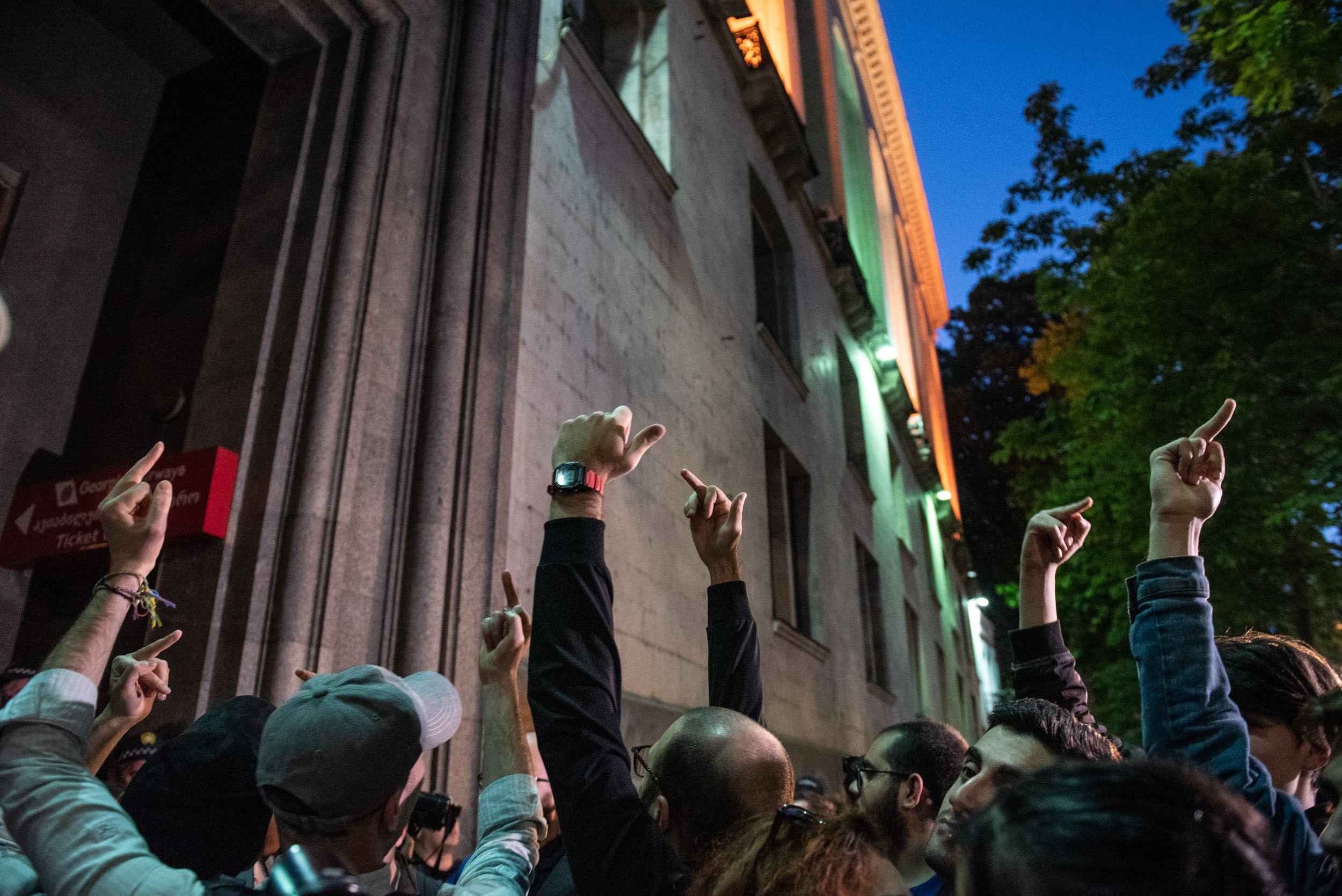 Protesters holding up their middle fingers outside the Georgian Airways office in Tbilisi on 16 May. Image: Mariam Nikuradze/OC Media