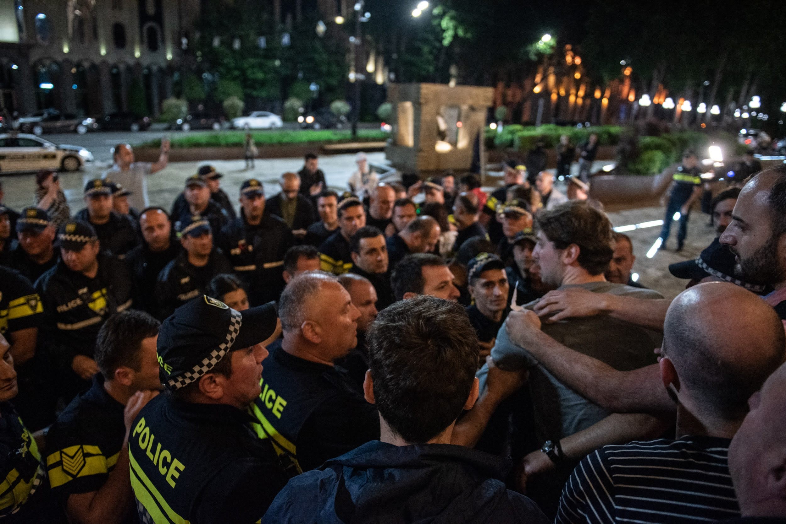 Activist Nika Romanadze was arrested for holding a sign insulting Prime Minister Irakli Gharibashvili. Photo: Mariam Nikuradze/OC Media.