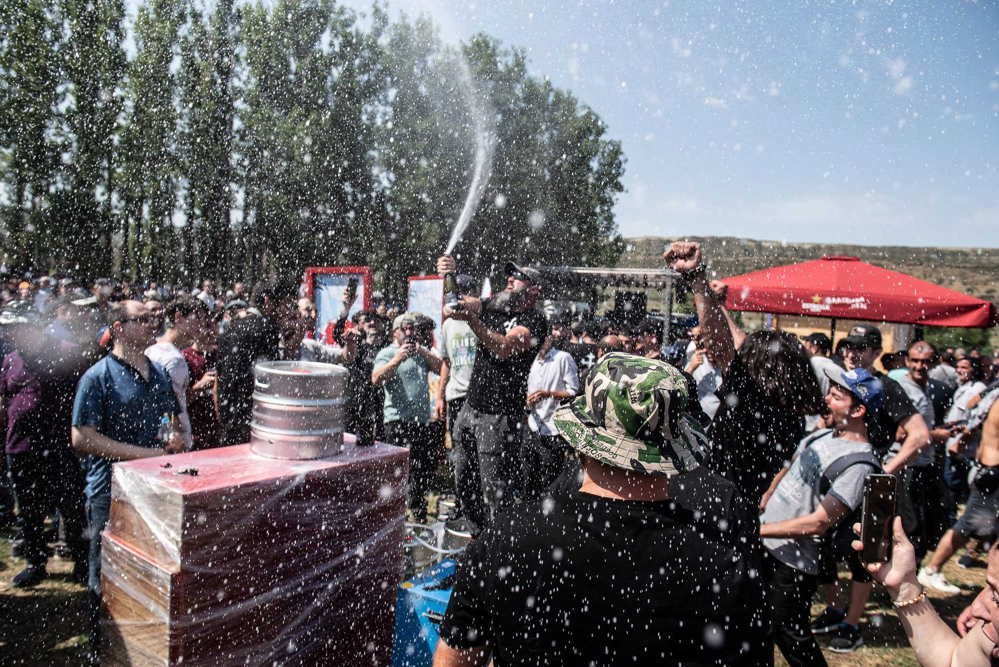 A protester opens a bottle of champagne at the festival site. Photo: Mariam Nikuradze/OC Media