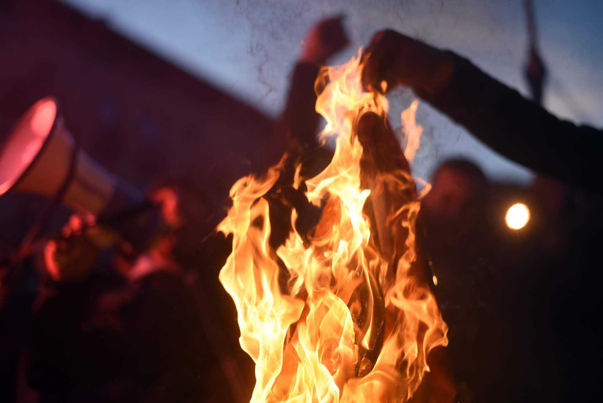 Protesters burn a homemade 'rainbow flag’ prior to the premiere of queer romance film And Then We Danced. Photo: Mariam Nikuradze/OC Media.