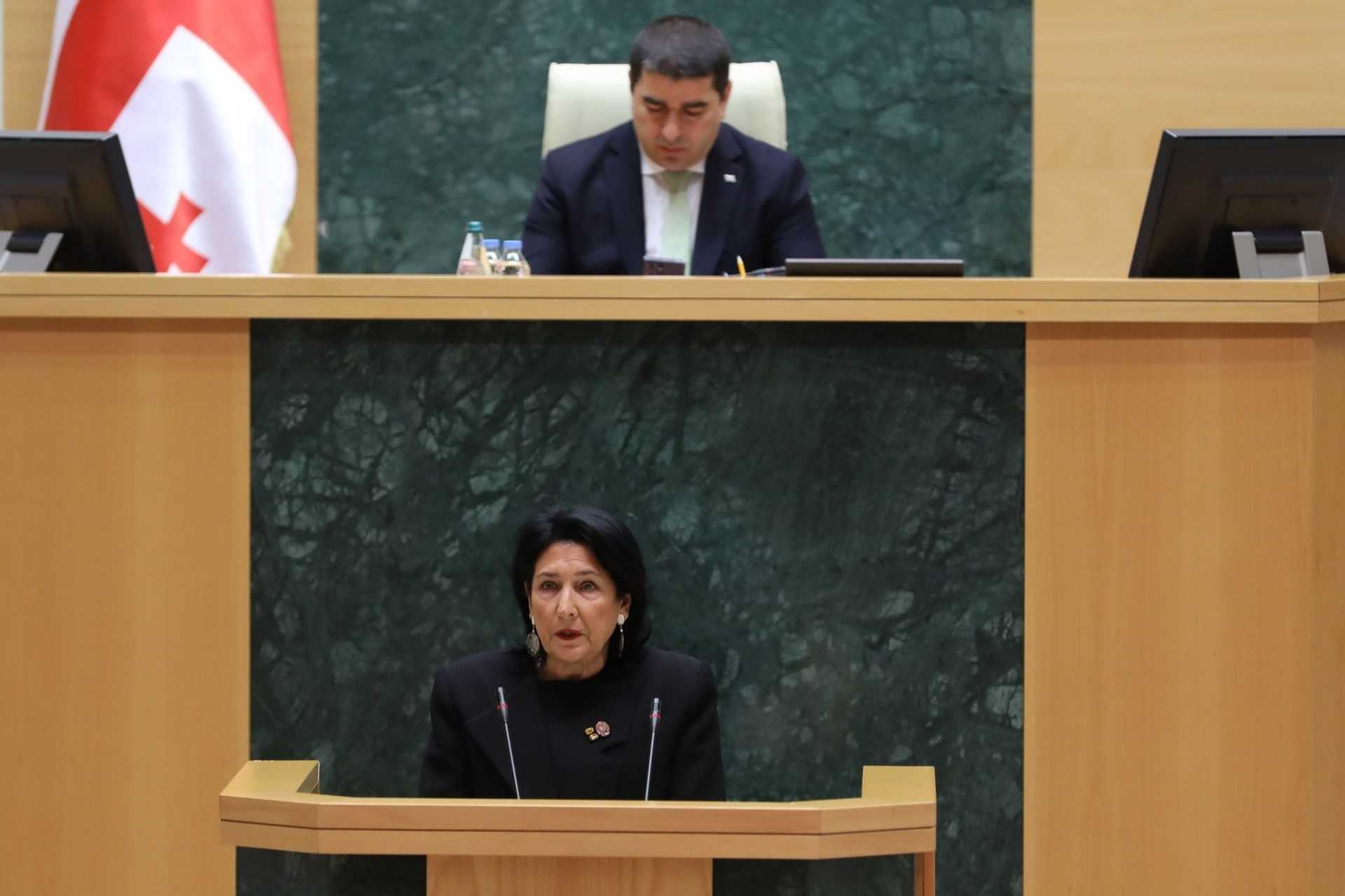 President Salome Zurabishvili presenting her annual report to parliament, with parliamentary speaker Shalva Papuashvili in the background. Image via parliament.