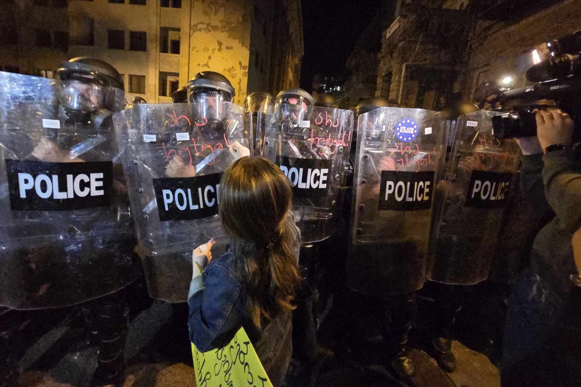 A protester faces off with riot police outside parliament on 16 April. Photo: Mariam Nikuradze/OC Media.