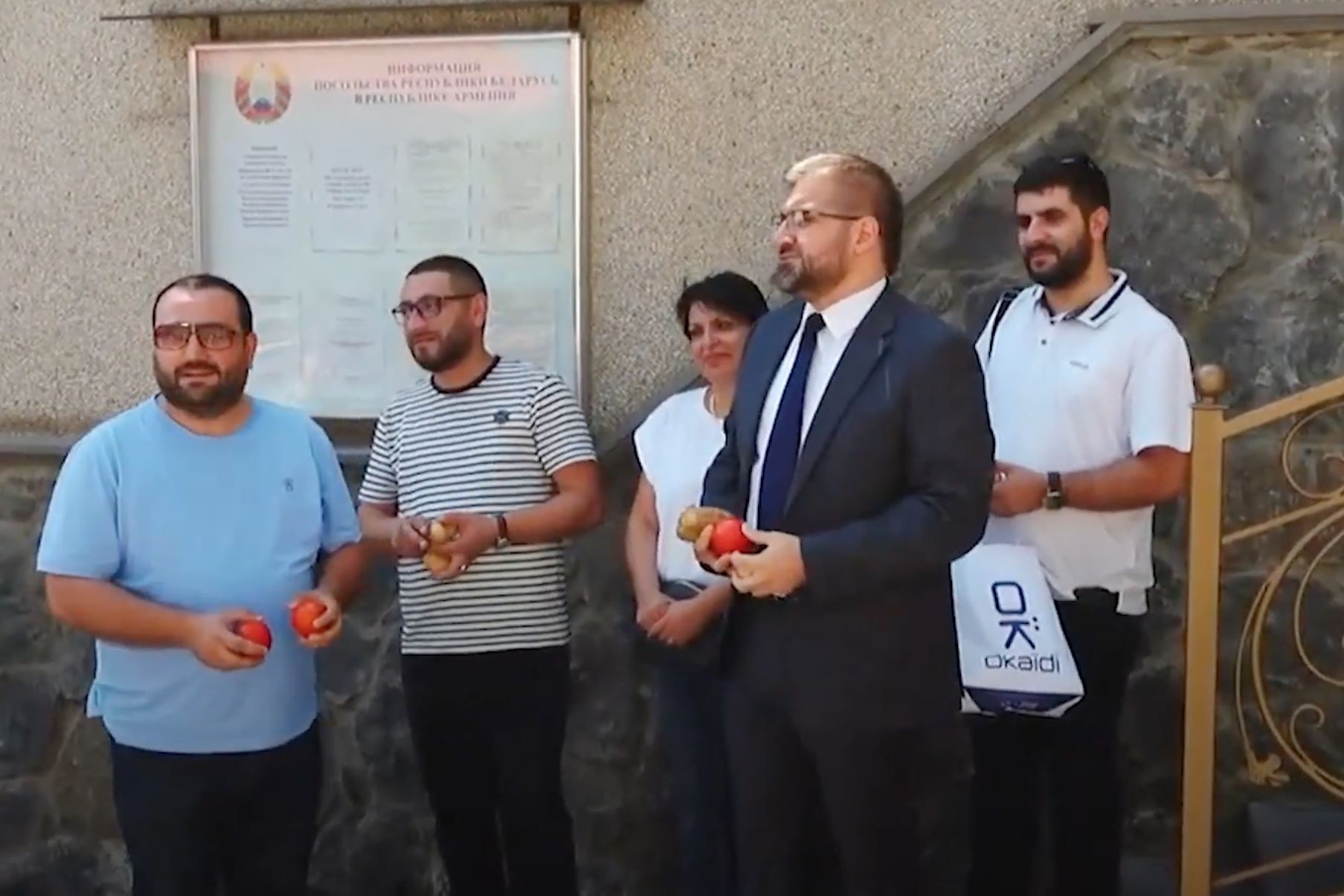 A group of protesters handling vegetables to throw at the Belarusian Embassy in Armenia. Screengrab via 1in.am