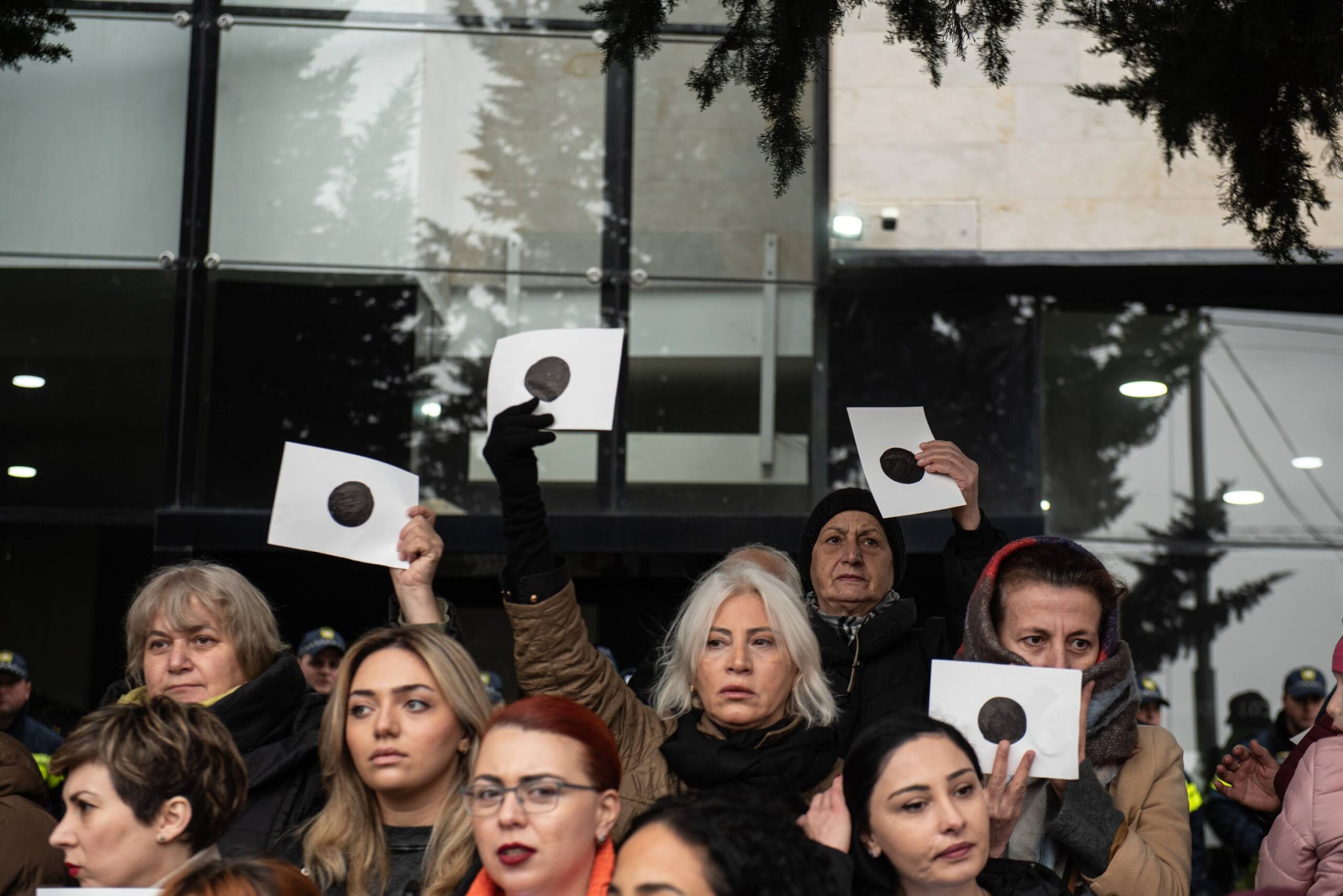 Protesters outside the CEC offices in Tbilisi on 13 November hold sheets with a large black circle in the centre, symbolising the visible ballot choices cast by Georgian voters. Image: Mariam Nikuradze/OC Media.