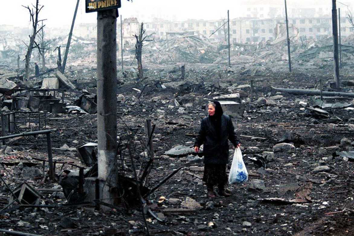 A woman in the wreckage of Grozny during the Second Chechen War. For illustrative purposes. Image via TASS.