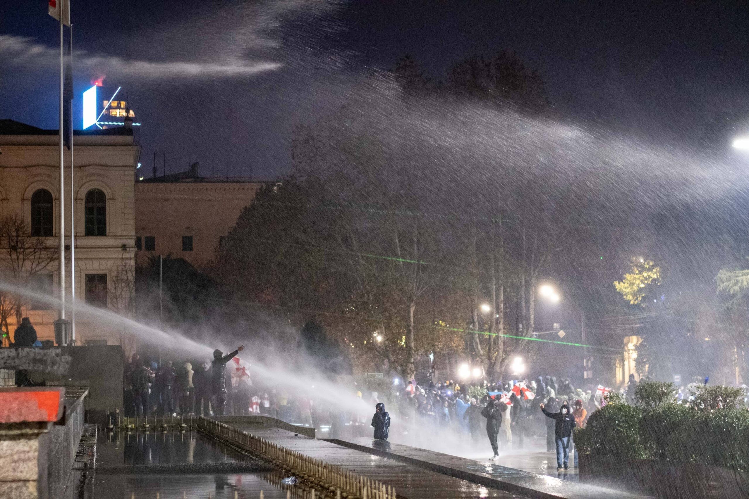 Police fire water hoses at protesters from the Georgian parliament building. Mariam Nikuradze/OC Media.