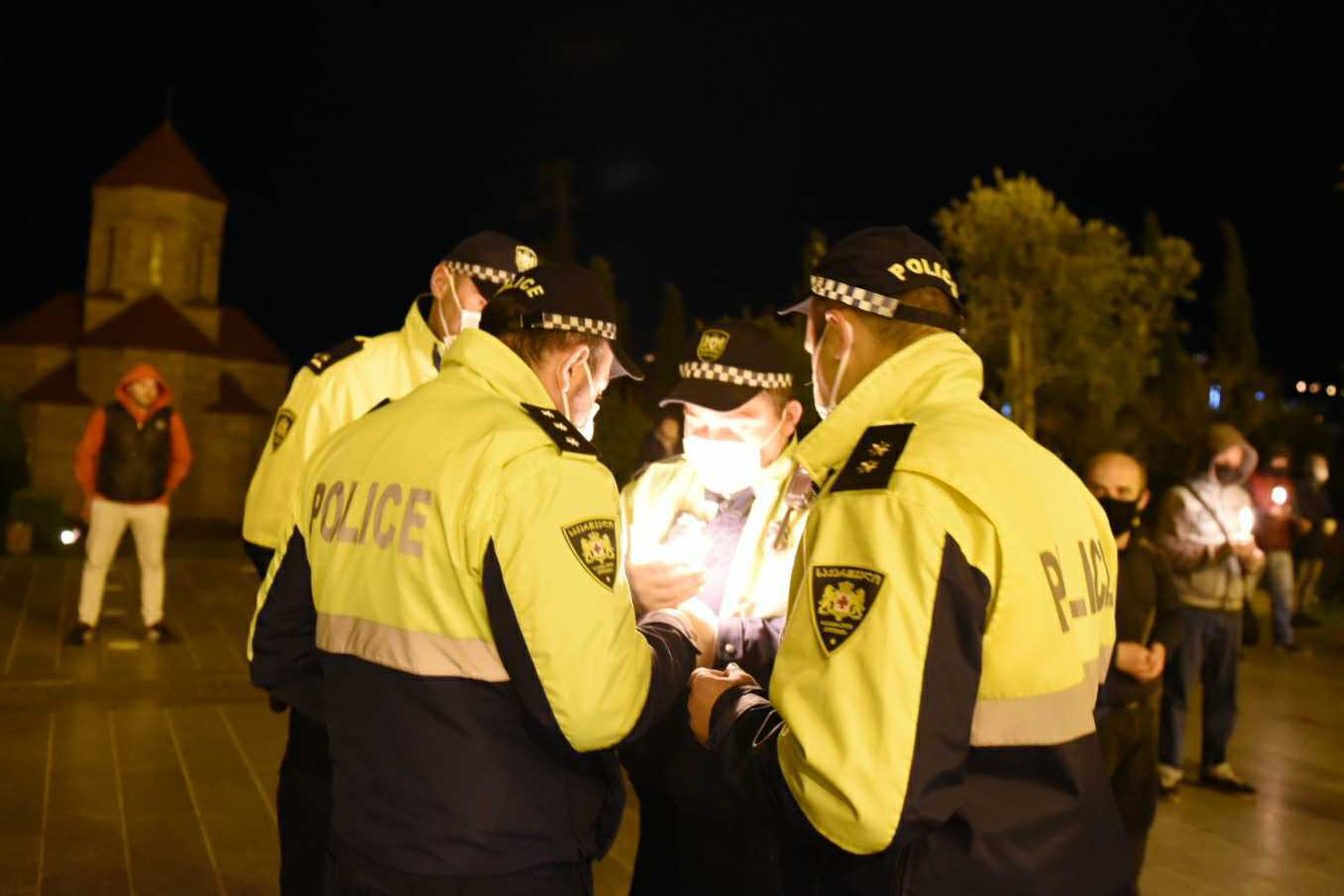 Police officers lighting candles at Sameba Trinity Cathedral. Photo: Mariam Nikuradze/OC Media.